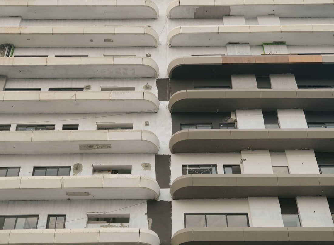 Close-up of a modern building facade showcasing geometric balconies and patterns, highlighting architectural detail.