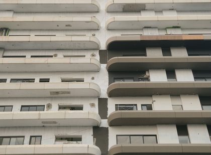 Close-up of a modern building facade showcasing geometric balconies and patterns, highlighting architectural detail.