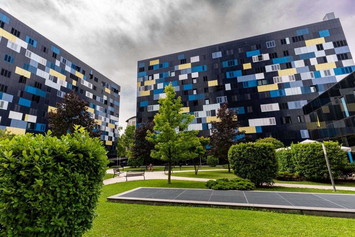 Colorful facade buildings in a green park area, showcasing modern design in Zagreb, Croatia.
