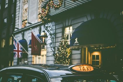 photo of taxi parking beside building