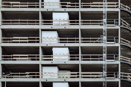 Close-up of a multi-storey building under construction, showcasing steel and concrete structure.
