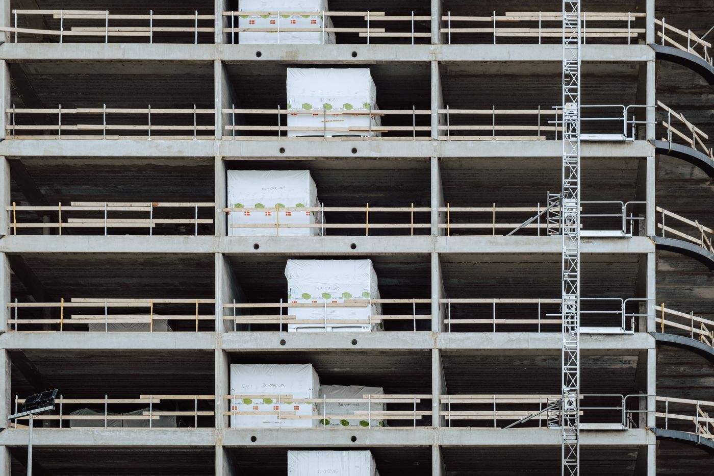 Close-up of a multi-storey building under construction, showcasing steel and concrete structure.