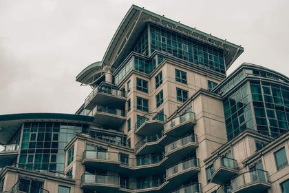 Detailed view of a modern architectural building in London with glass facades and balconies.