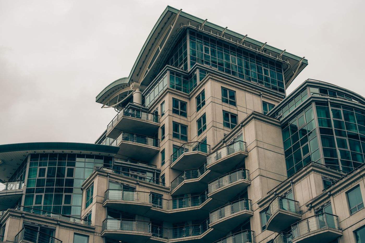 Detailed view of a modern architectural building in London with glass facades and balconies.