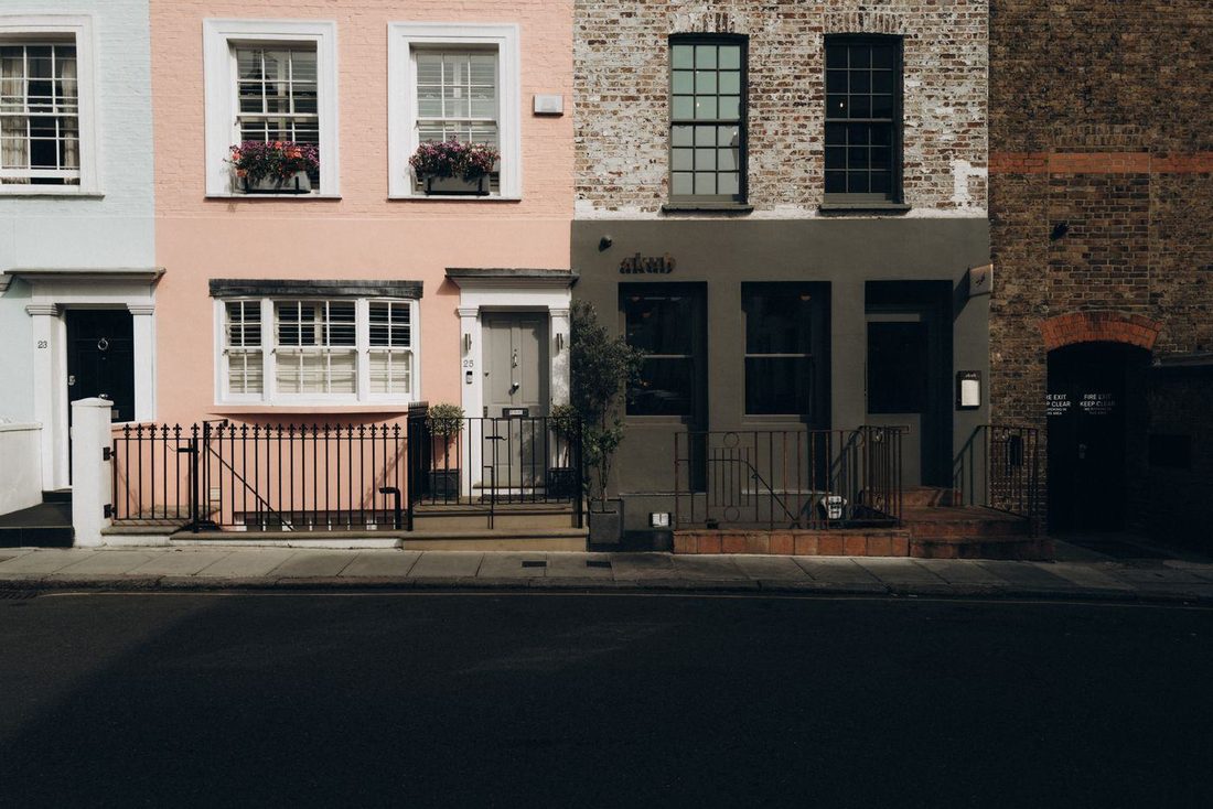 Colorful townhouses in Notting Hill, London, showcasing classic architectural details.