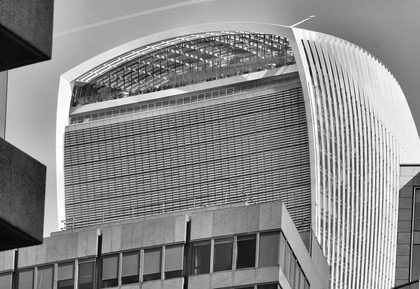 Black and white photo of the Walkie Talkie building in London's urban landscape.