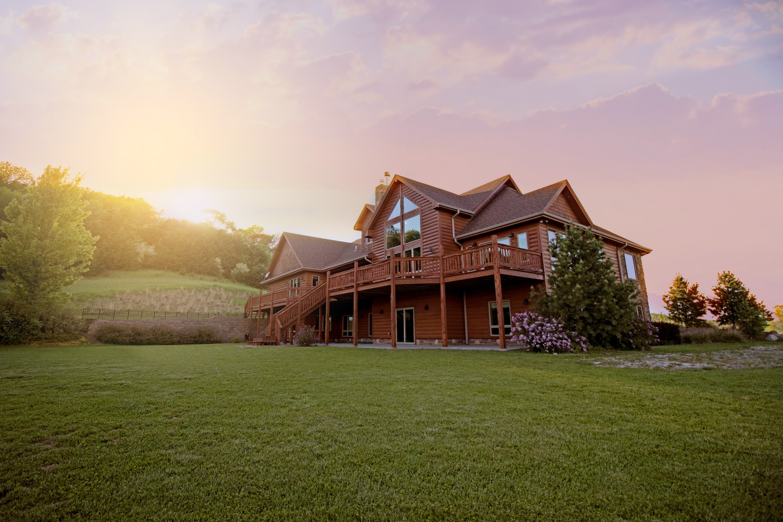 brown wooden house with green grass field