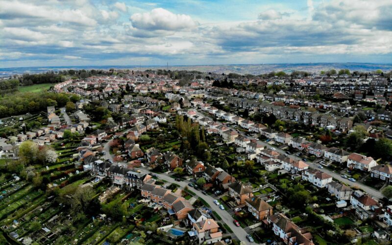 an aerial view of a city with lots of houses