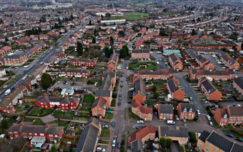 an aerial view of a city with lots of houses