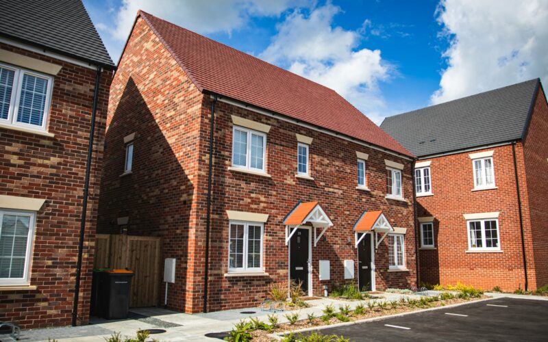 brown brick house under blue sky during daytime