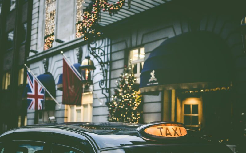 photo of taxi parking beside building