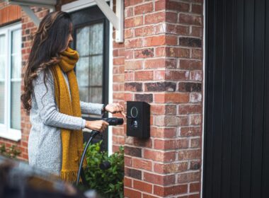 a woman is opening the door of her house