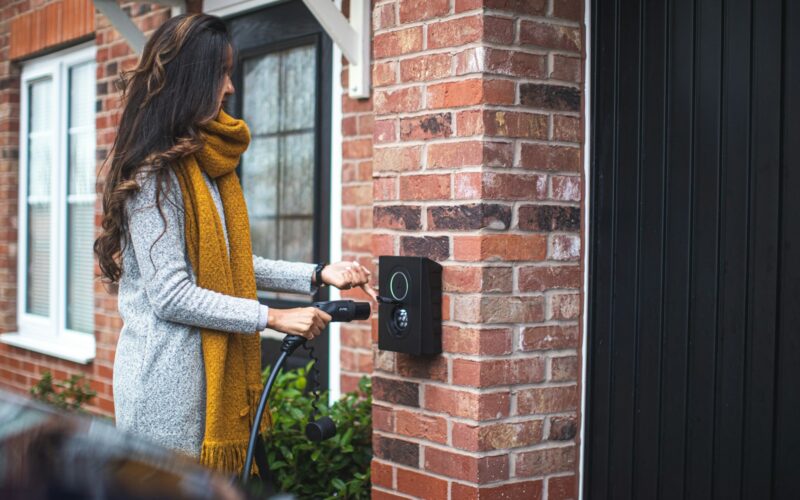 a woman is opening the door of her house