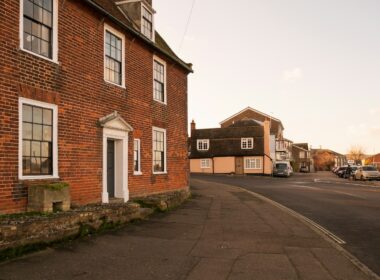 A brick building with a white door and windows