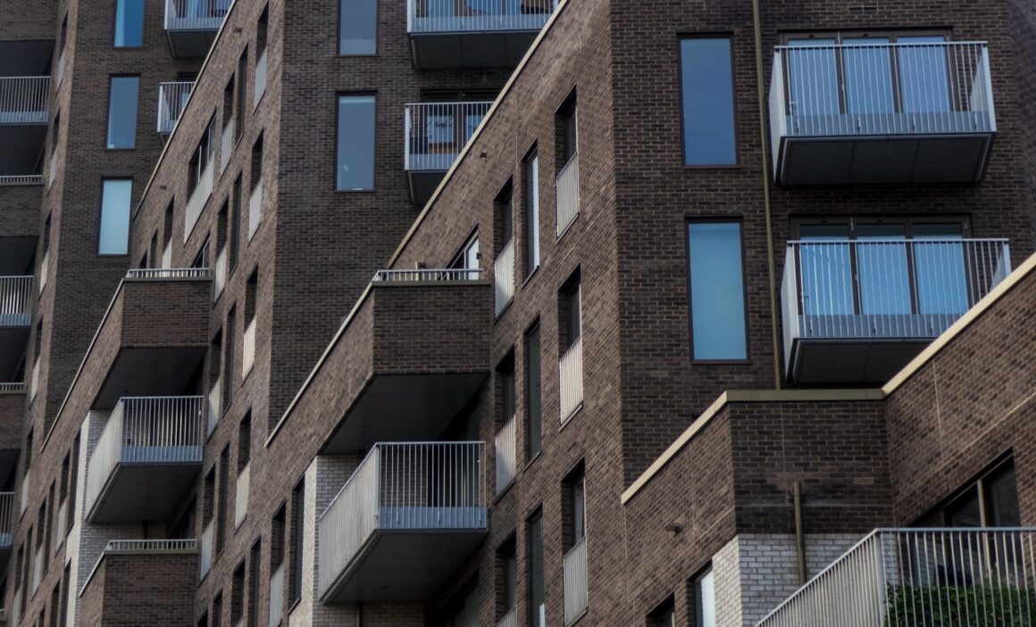 a tall brick building with balconies and balconies