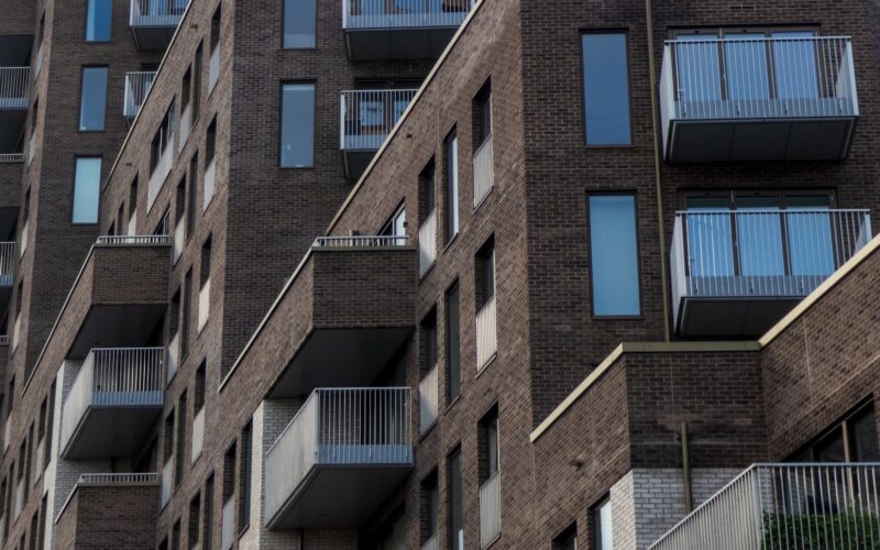 a tall brick building with balconies and balconies